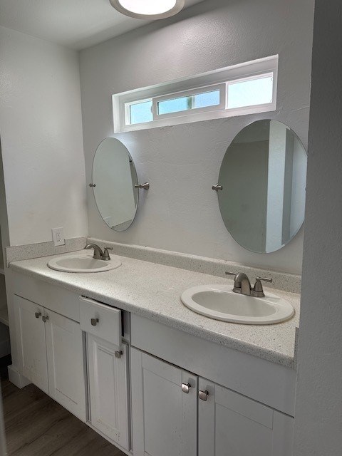 A bathroom with two sinks and two mirrors.