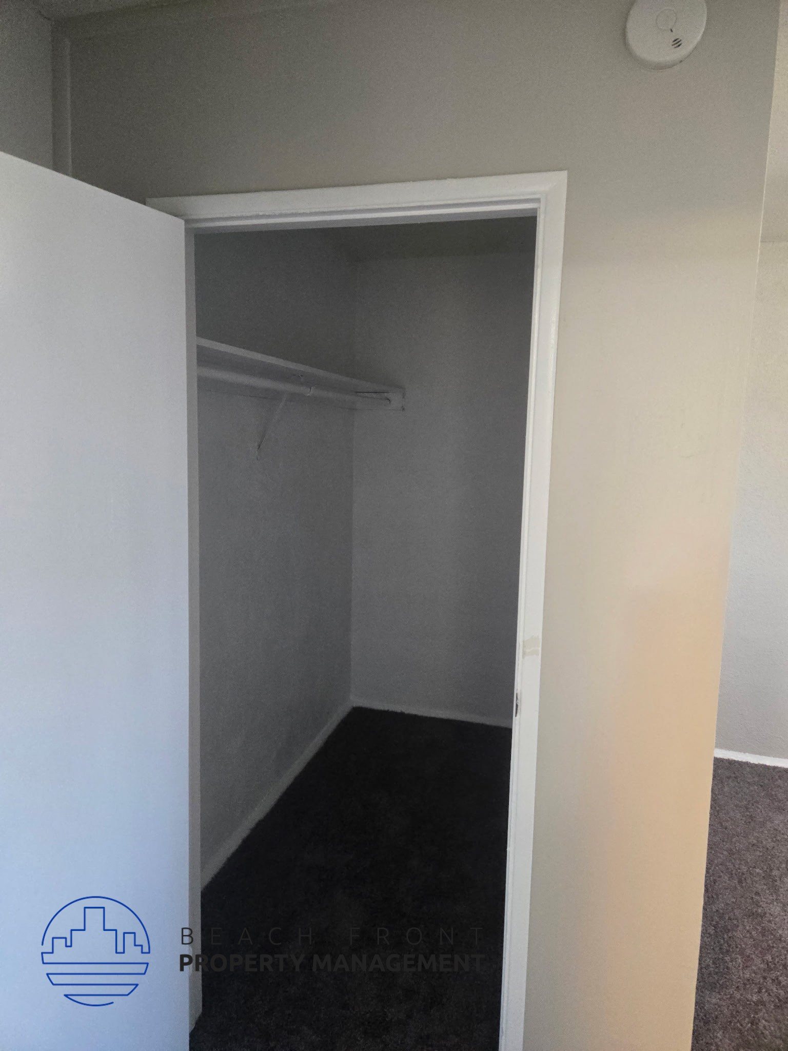 A small, empty room with a doorway leading to another room.