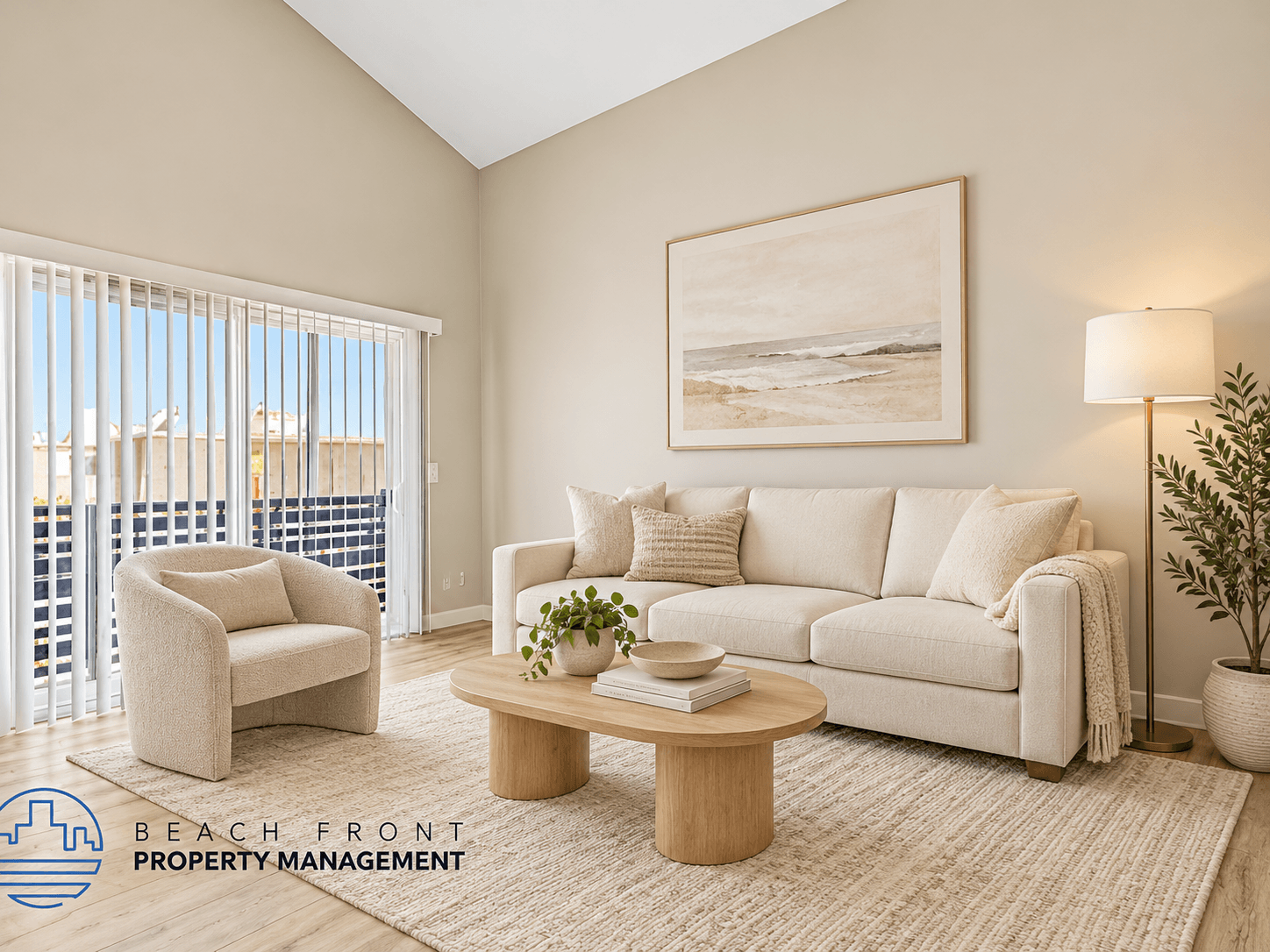 A living room with a large window overlooking the beach.