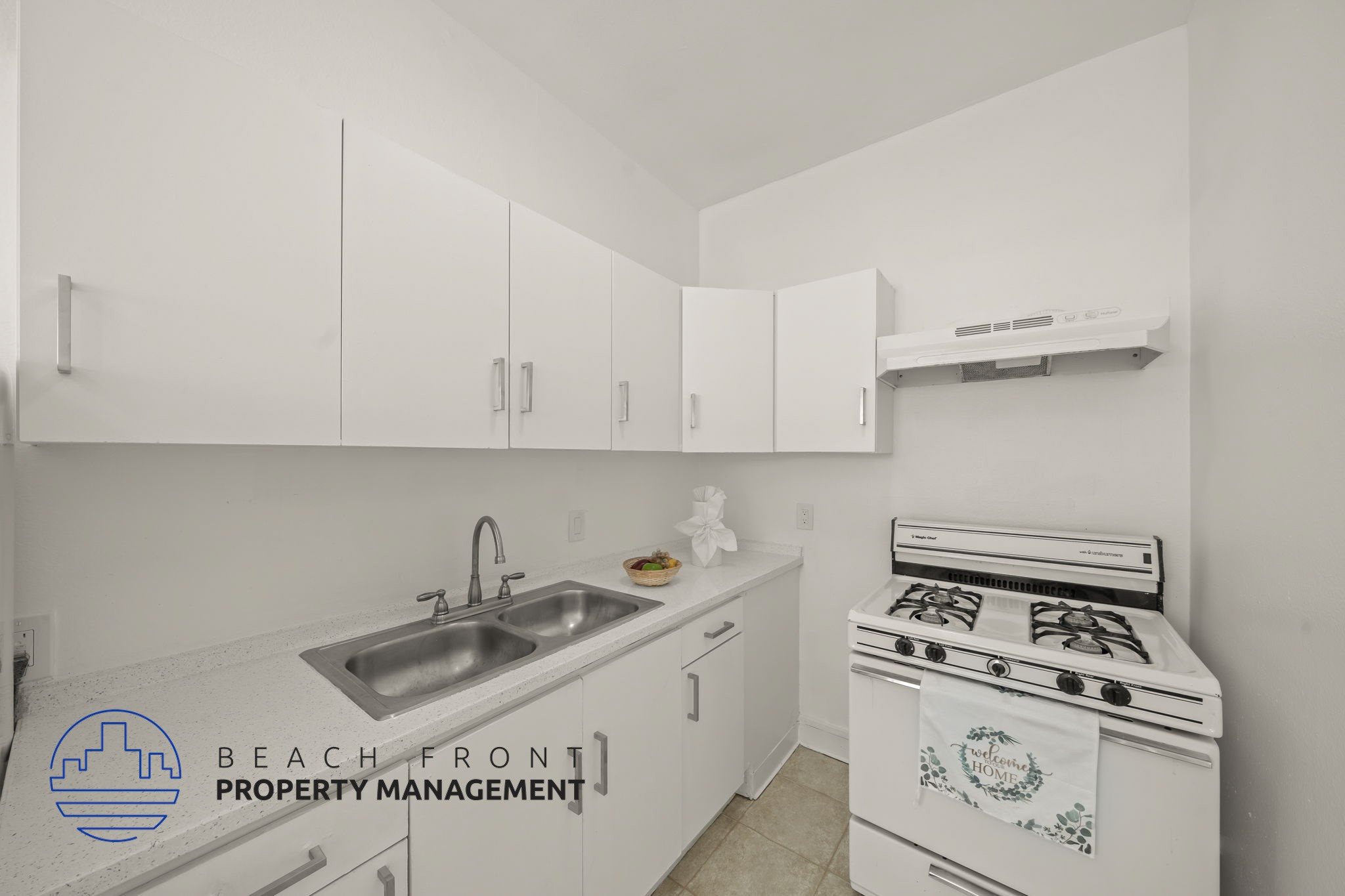 A kitchen with a stove and sink.
