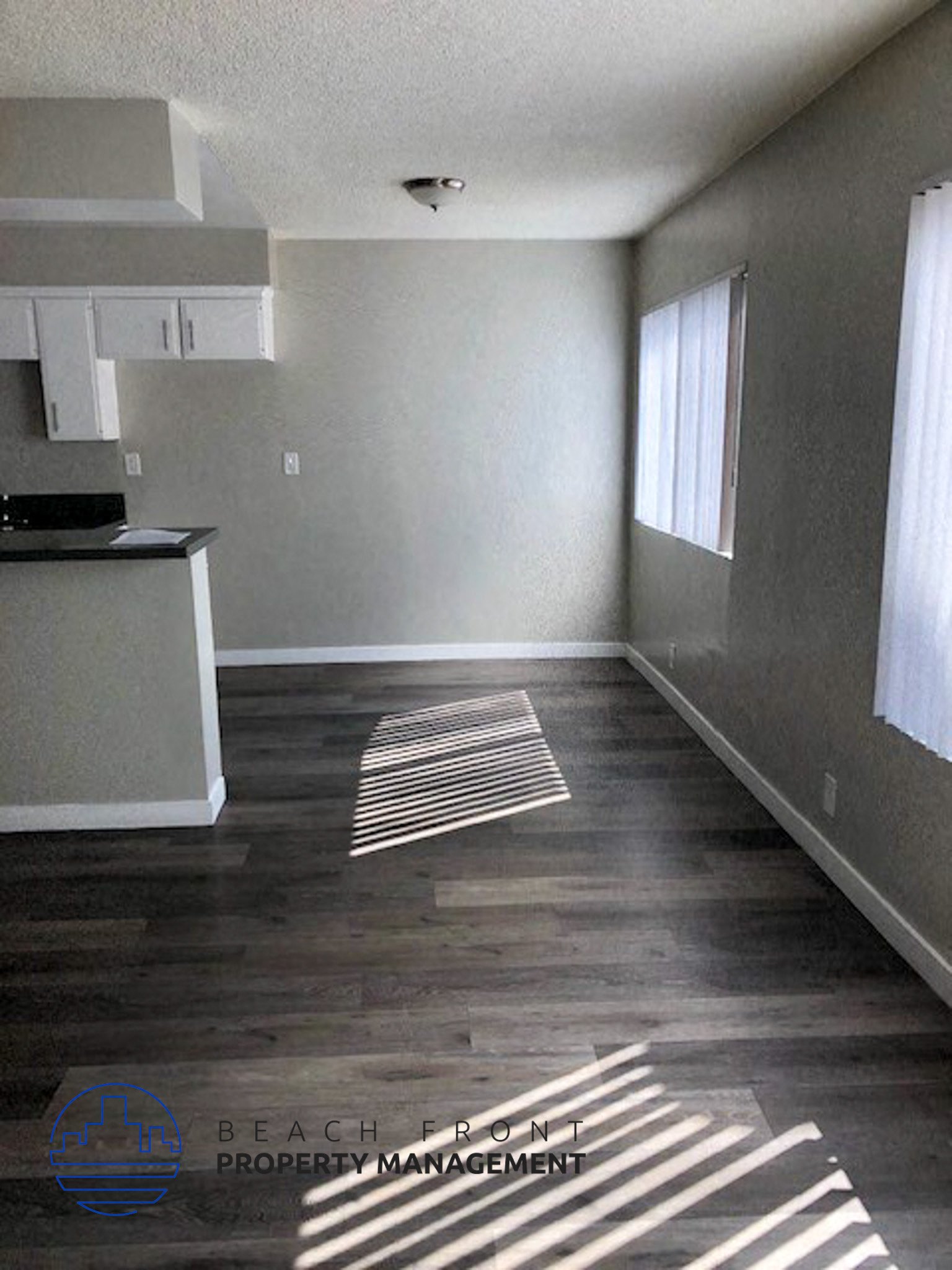 an empty room with the sun shining through the window