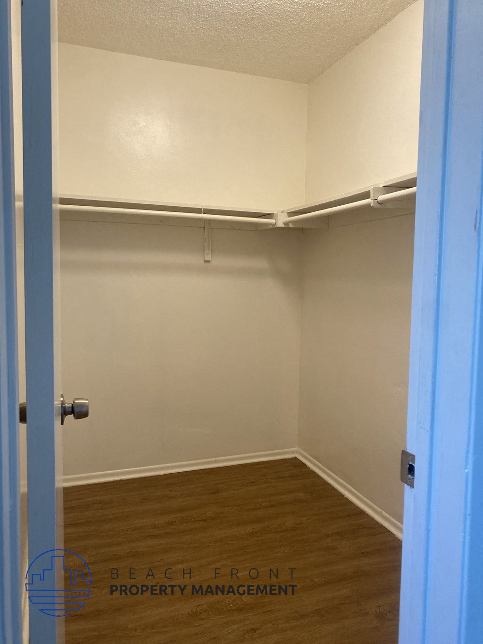 a room with a closet and a blue door