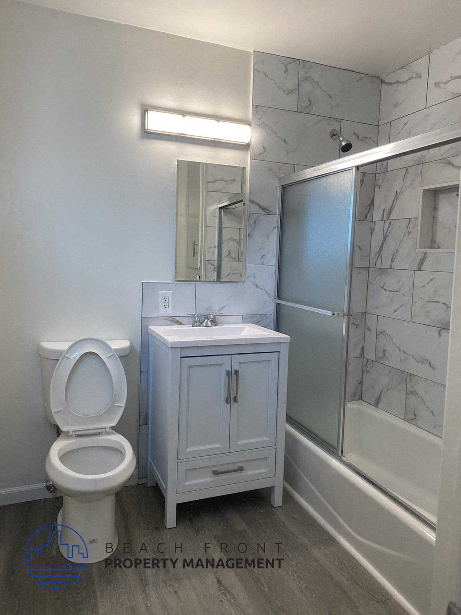 a bathroom with a toilet and a sink and a shower