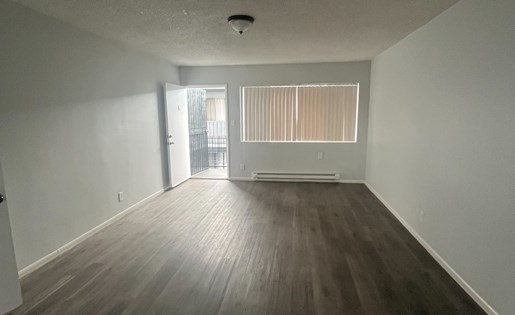 A room with wooden floors and white walls.