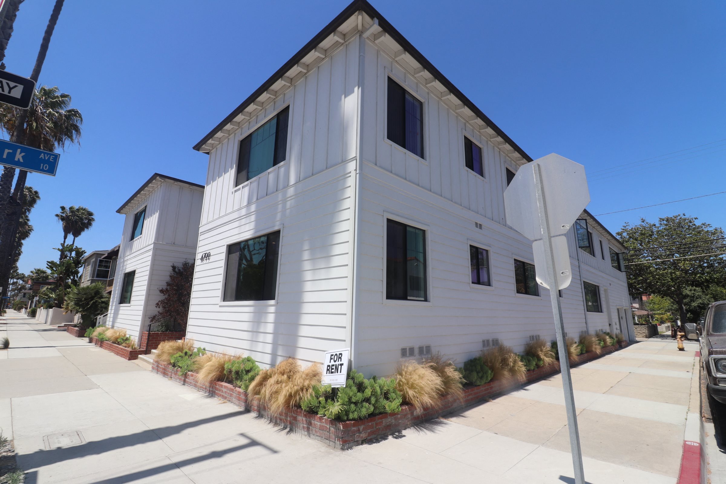 A white building with a sign that says