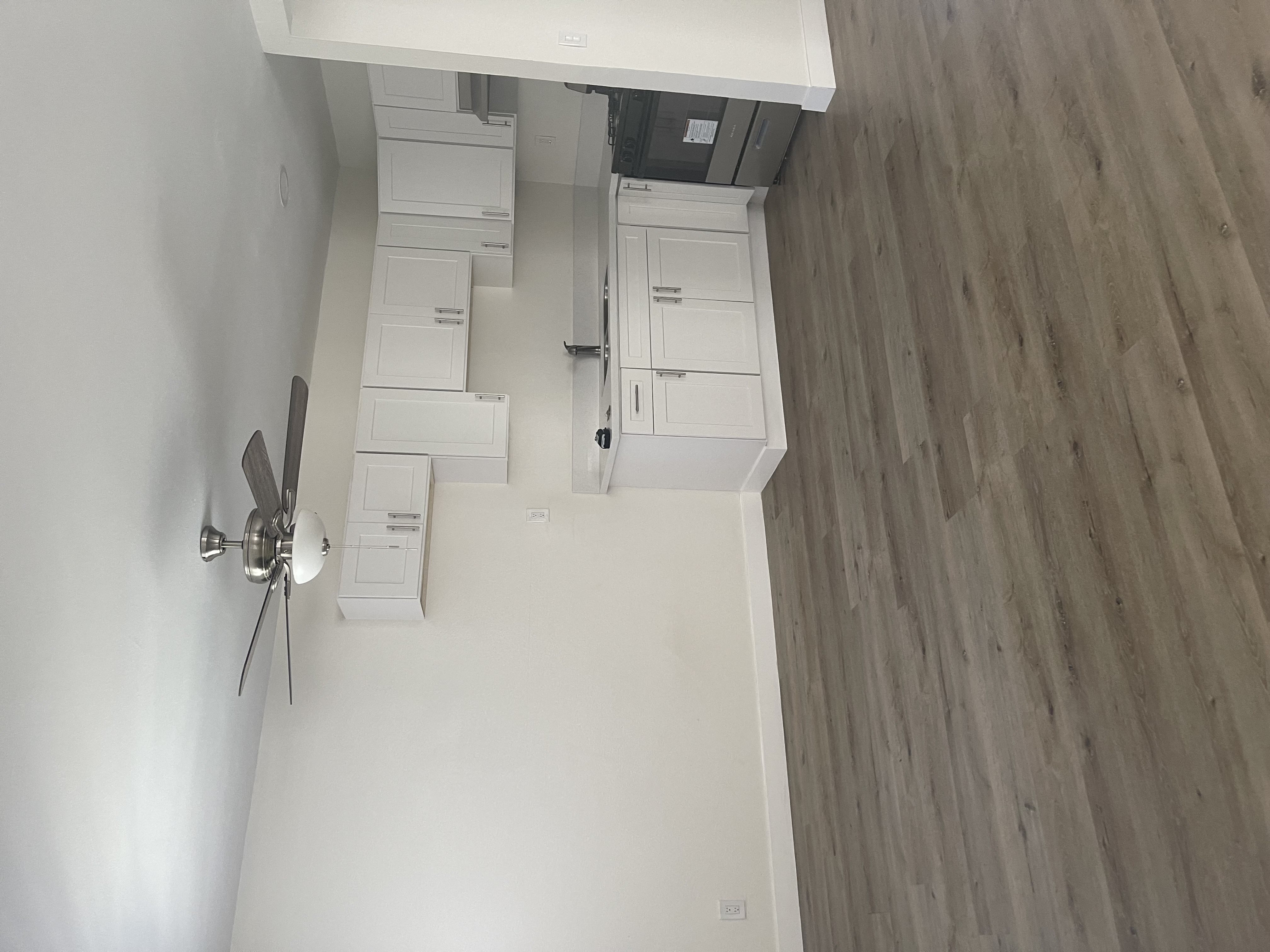 an overhead view of a living room with white walls and wooden floors