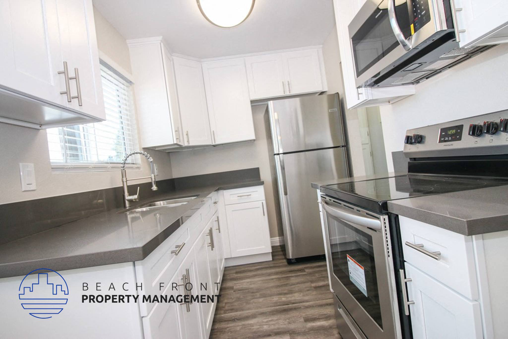 a kitchen with white cabinets and stainless steel appliances