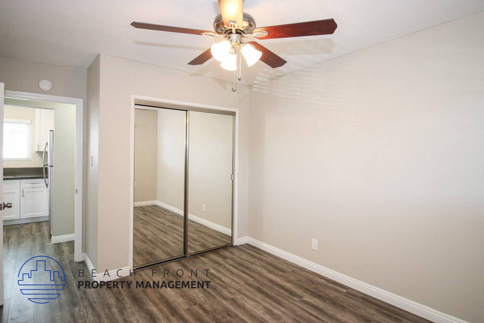 a bedroom with a ceiling fan and a closet