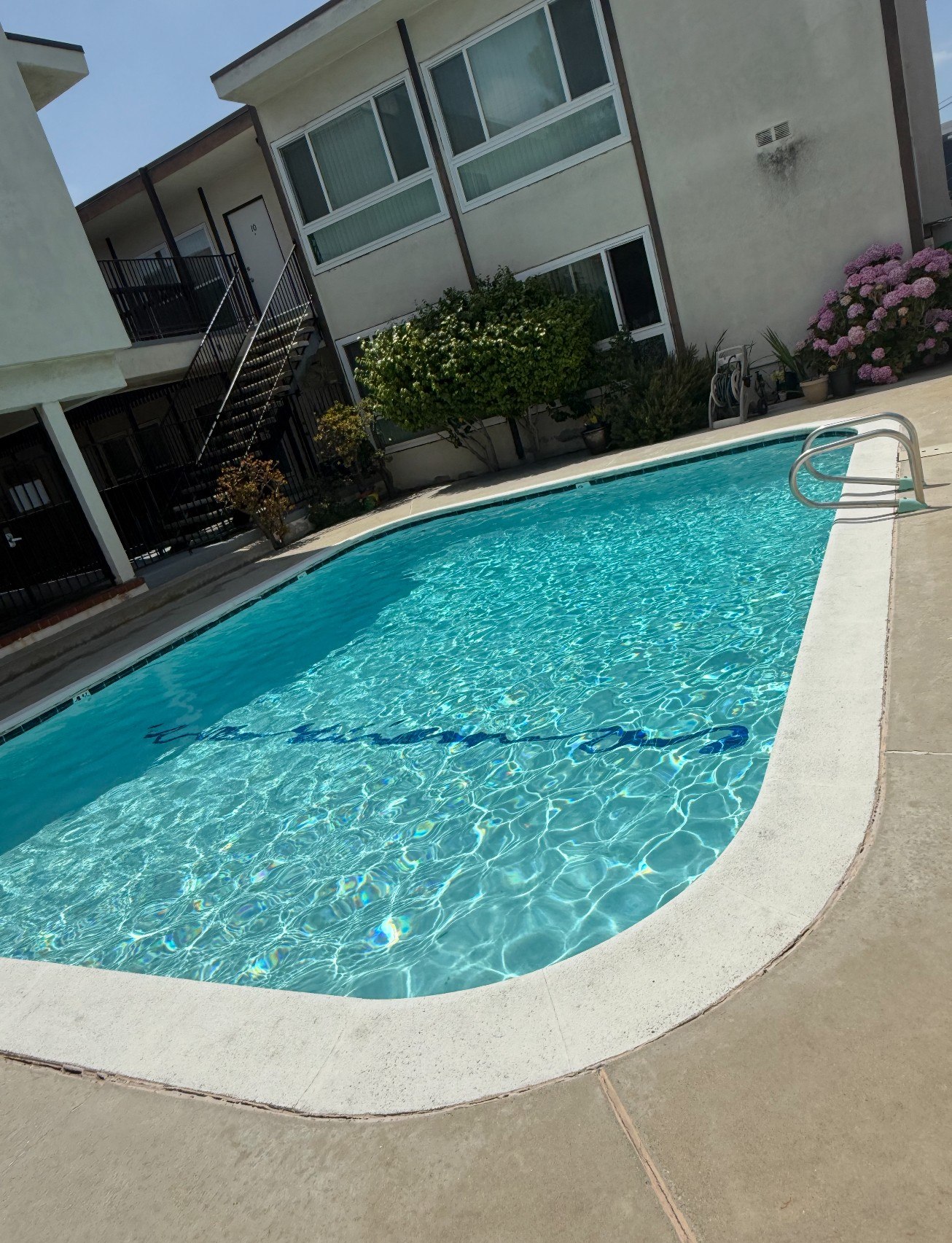 A small pool with a ladder in the middle.