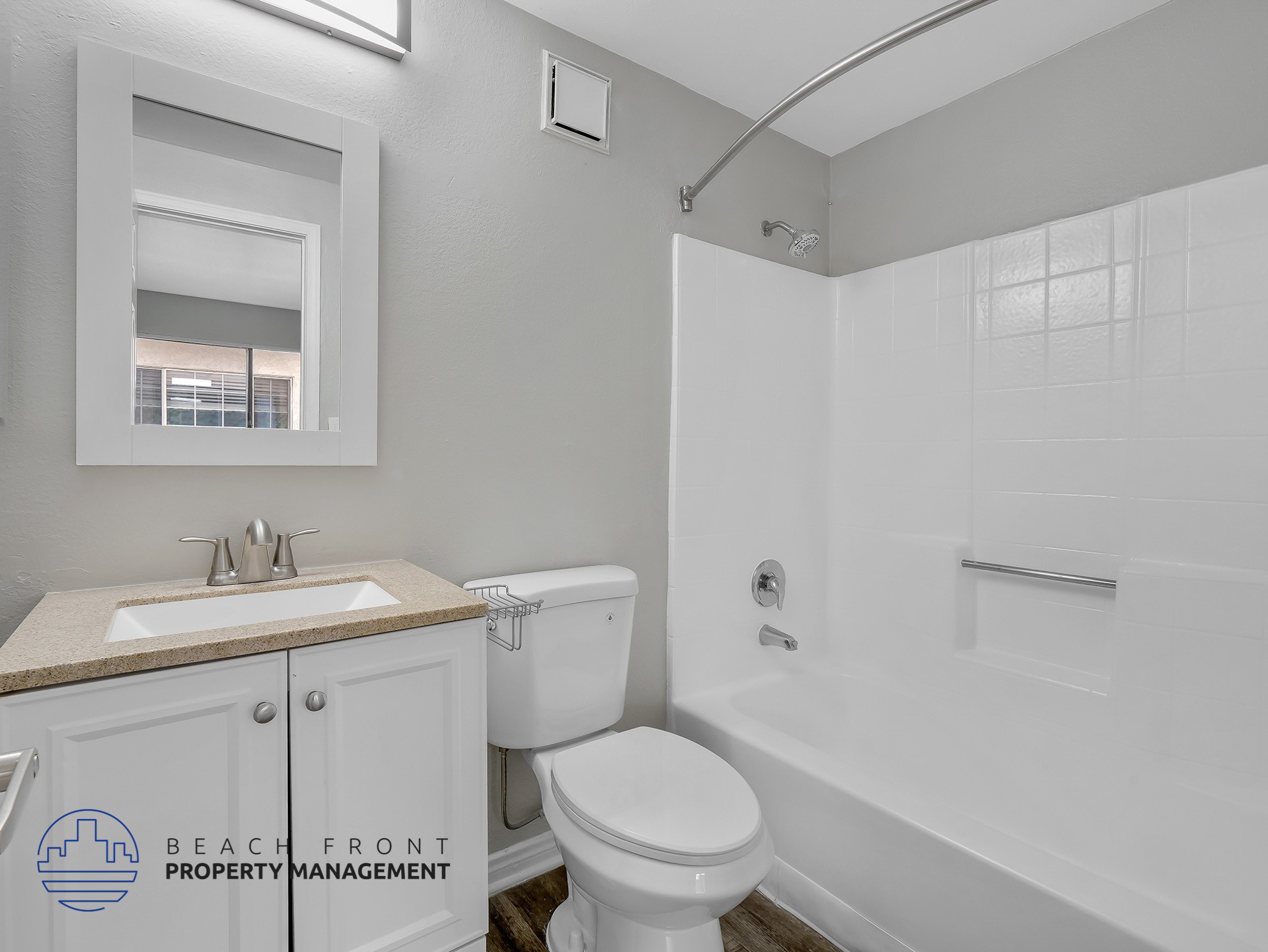 A white bathroom with a toilet, sink, and bathtub.