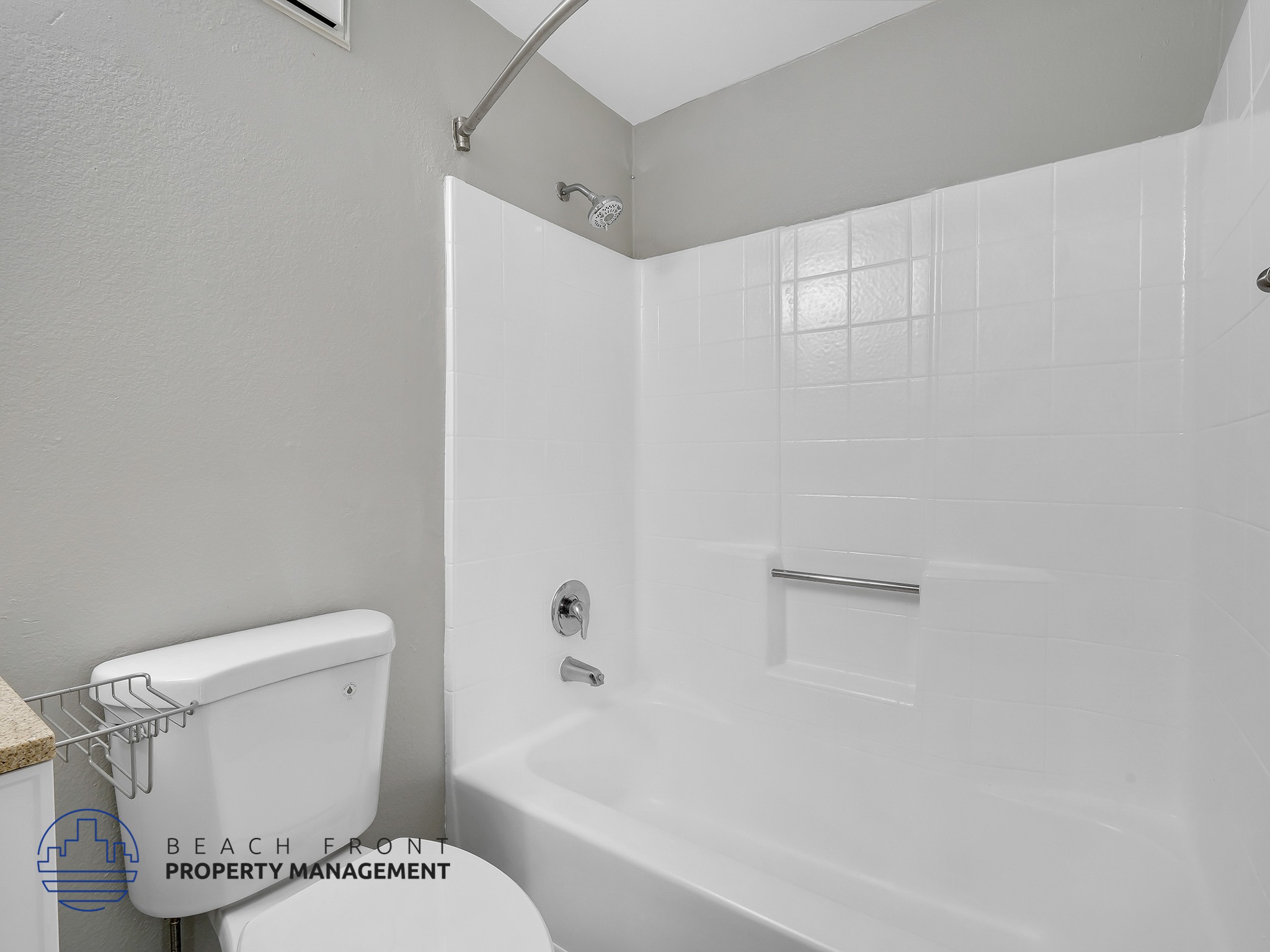 A white bathroom with a walk-in shower and a toilet.