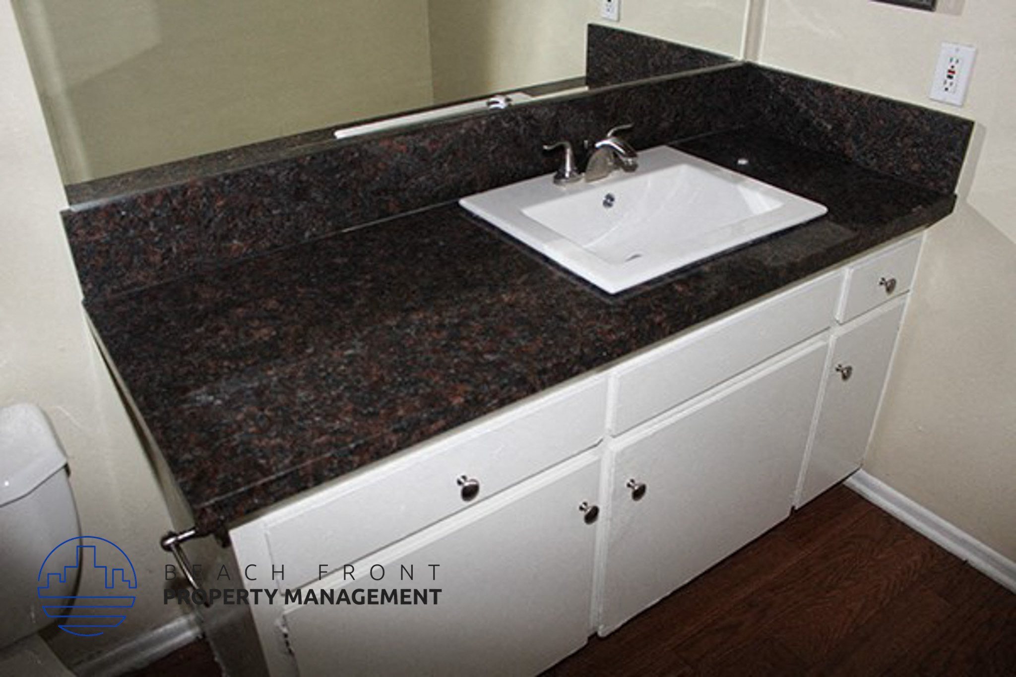 a bathroom with a sink and a granite counter top,a bathroom with a sink and a granite counter top