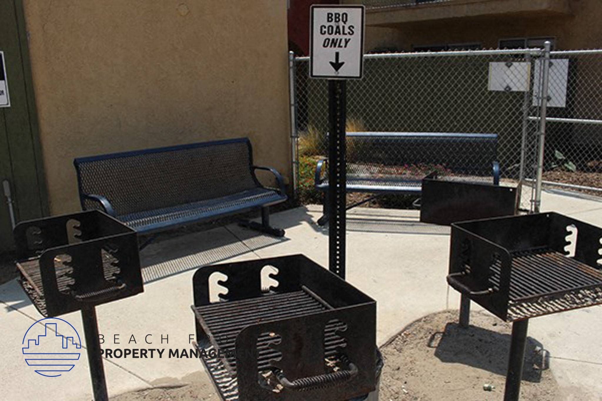 a street sign and benches on a sidewalk,a street sign and benches on a sidewalk