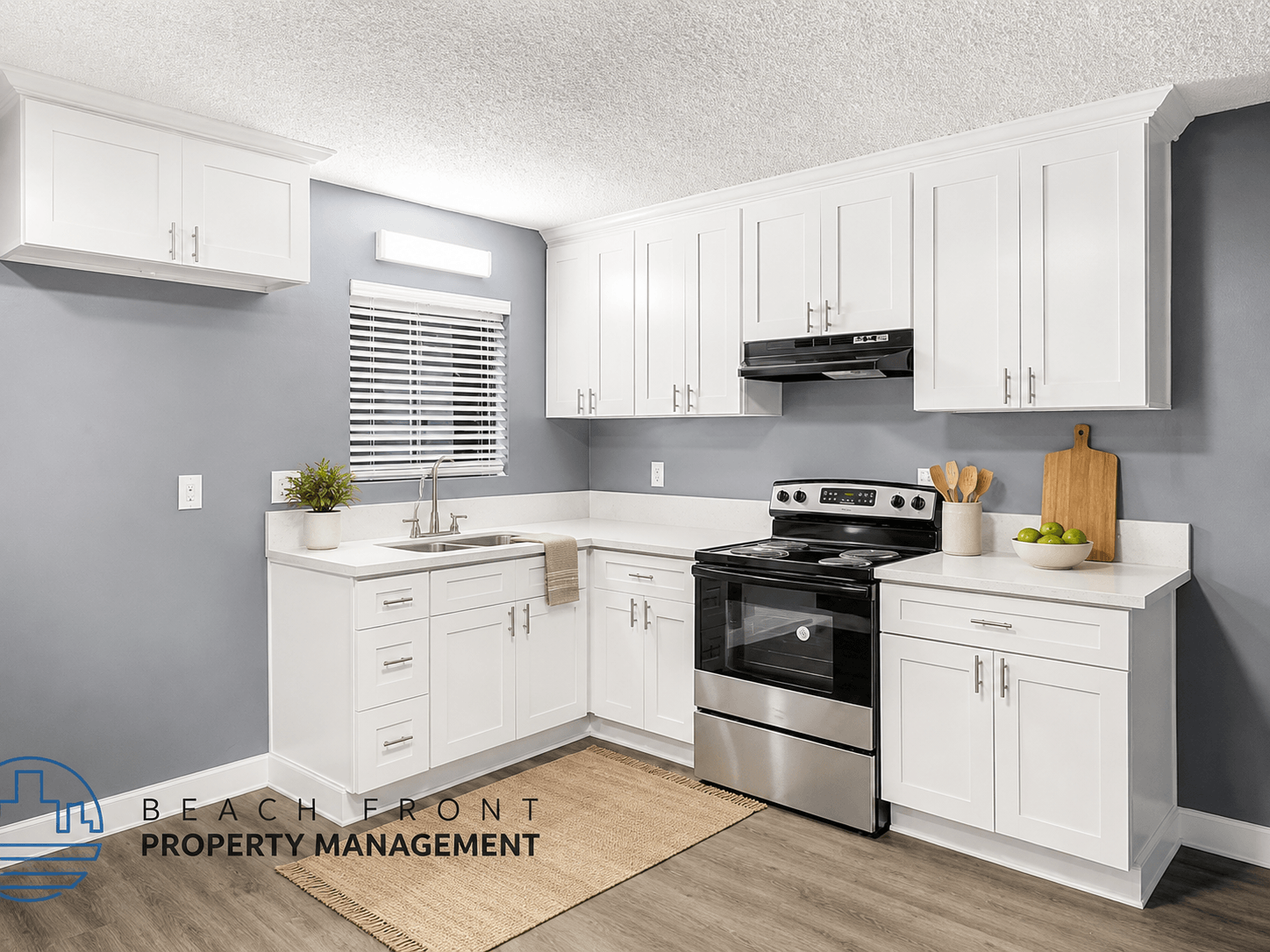 A kitchen with white cabinets and a stainless steel stove.