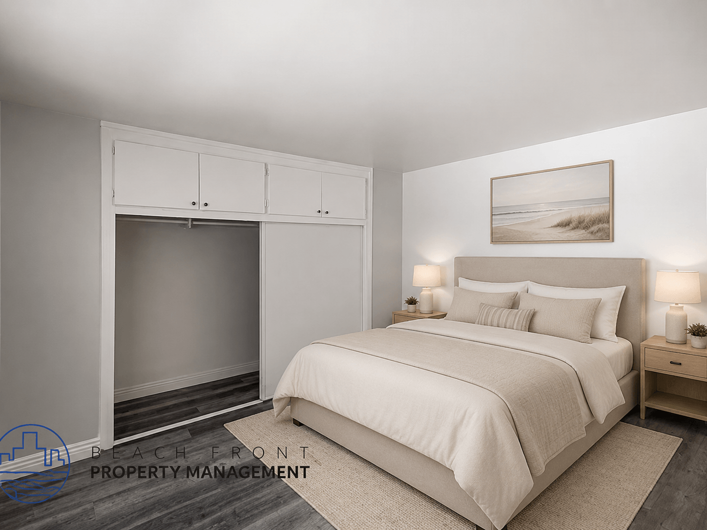 A bedroom with a large bed, a fireplace, and a painting on the wall.