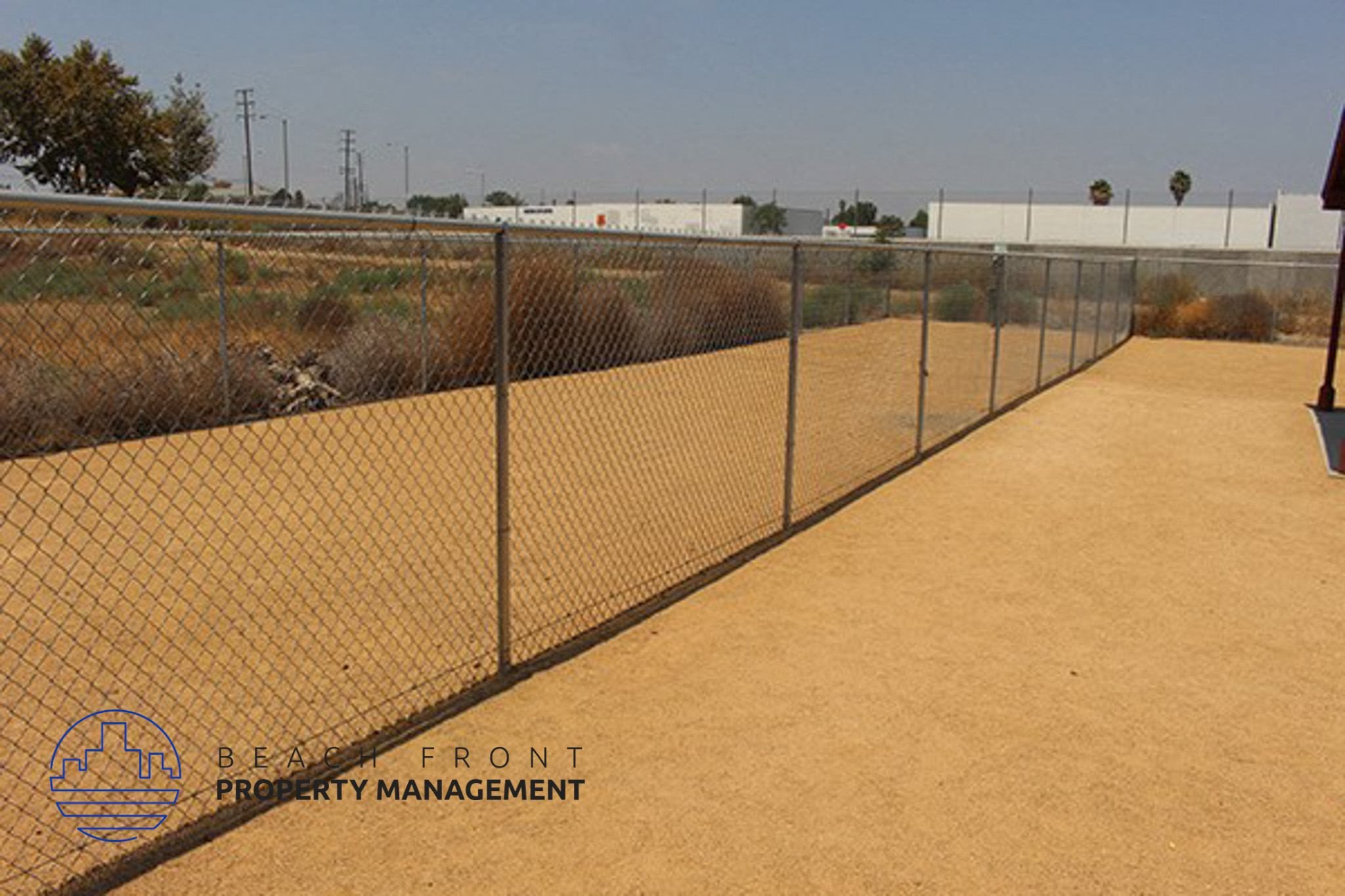 a chain link fence with a dirt path next to it,a chain link fence with a dirt path next to it
