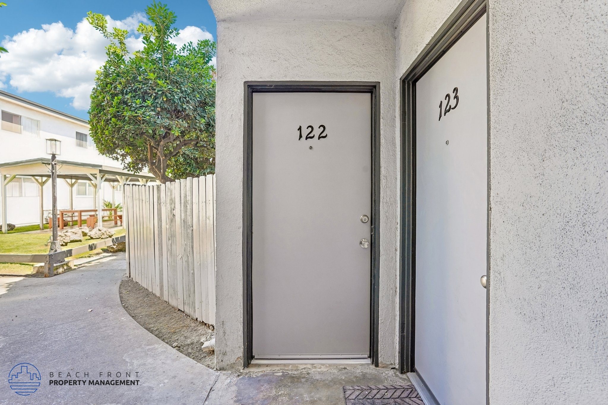 A grey door with the number 122 on it is closed.