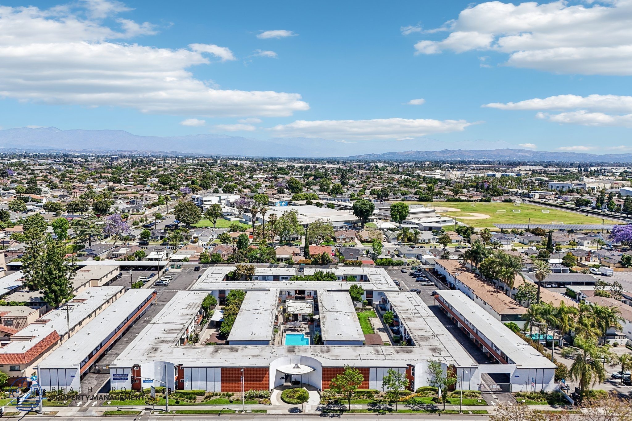A large industrial complex with multiple buildings and a parking lot in the foreground.