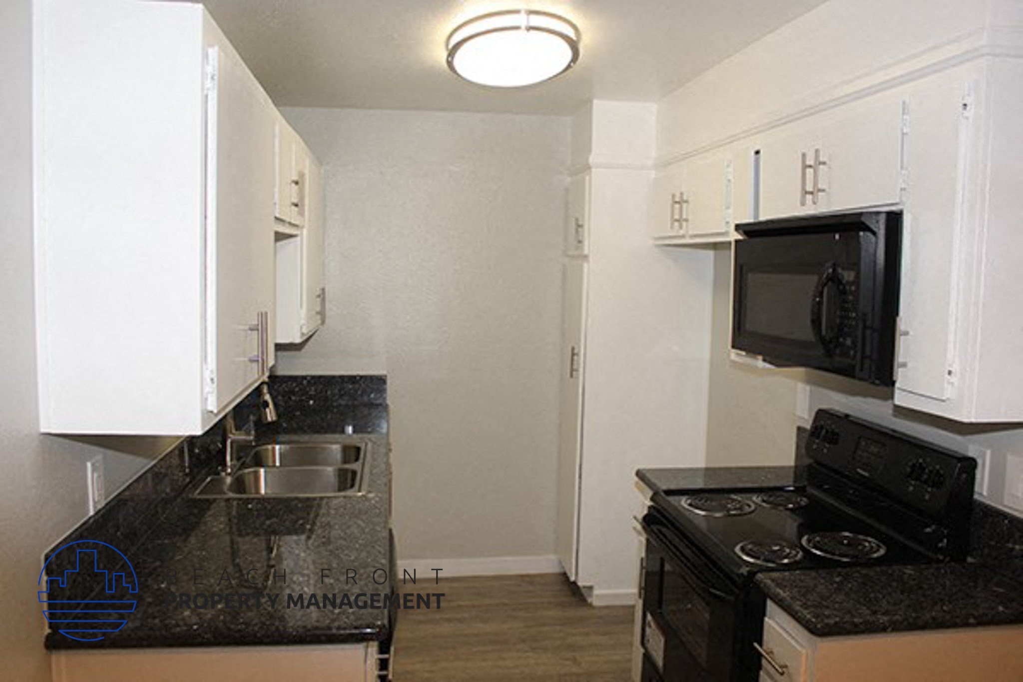 a kitchen with a stove and a sink and a microwave,a kitchen with a stove and a sink and a microwave
