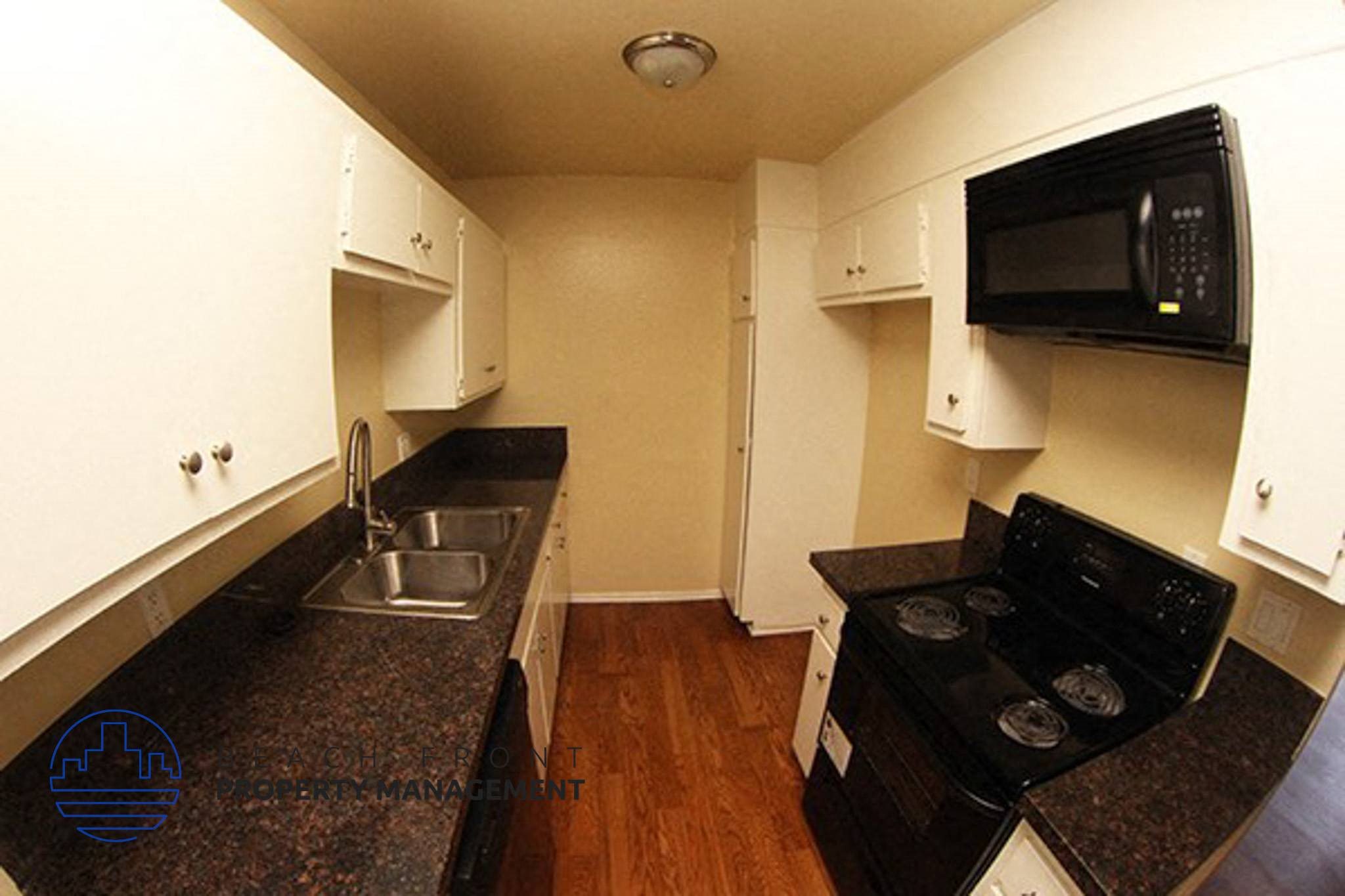 a kitchen with a sink and a stove and a microwave,a kitchen with a sink and a stove and a microwave