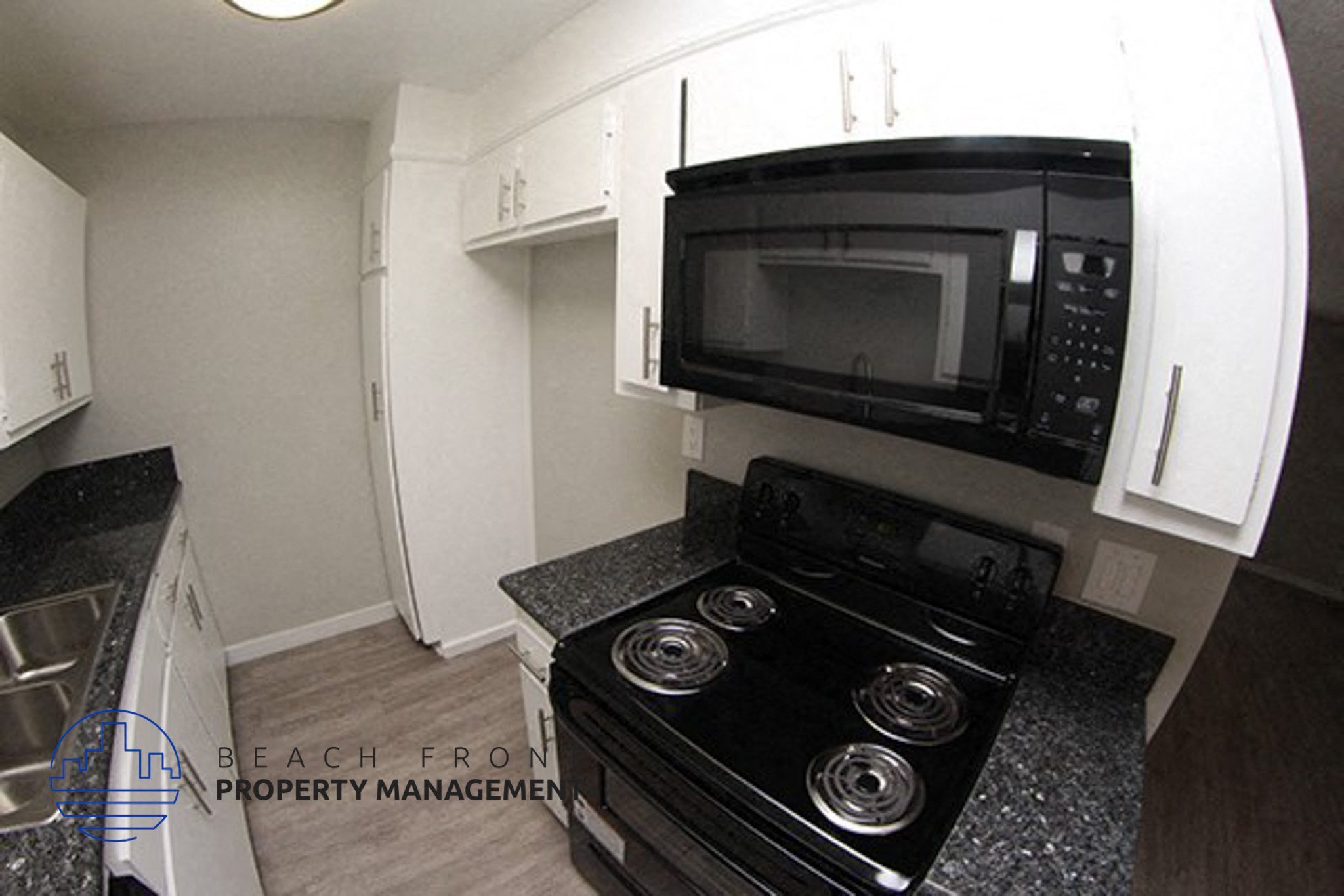 a kitchen with a stove and a microwave,a kitchen with a stove and a microwave