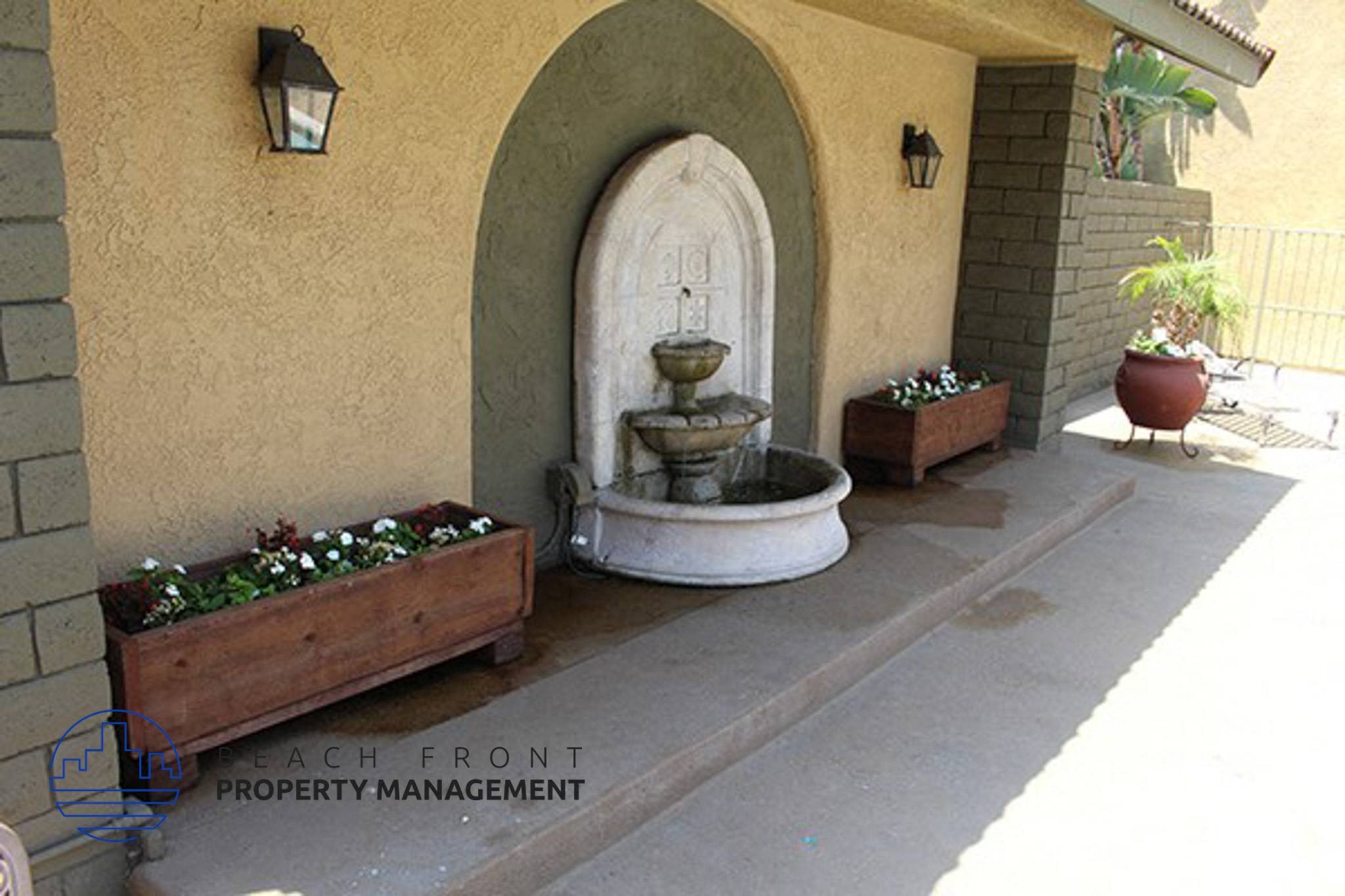 a fountain in the courtyard of a building,a fountain in the courtyard of a building
