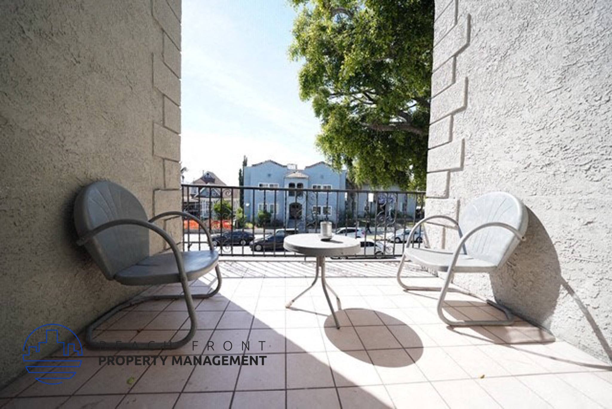 a patio with chairs and a table on a balcony