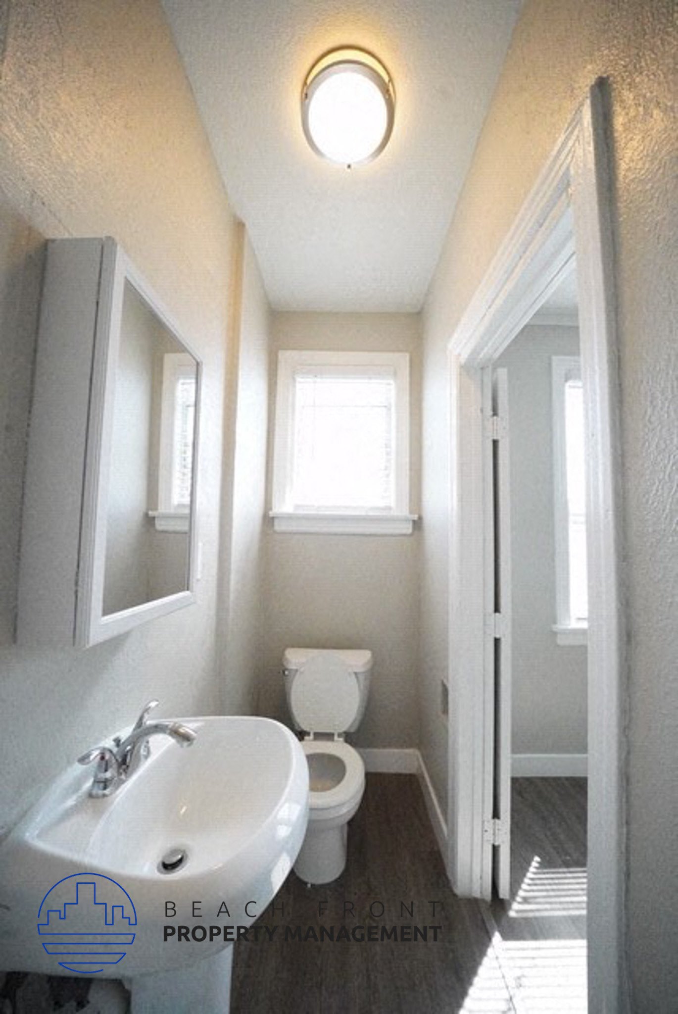a bathroom with a toilet and a sink and a window
