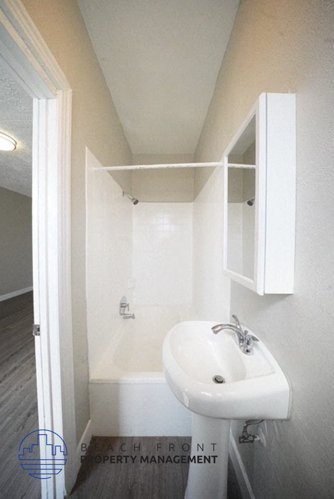 a white bathroom with a sink and a cabinet