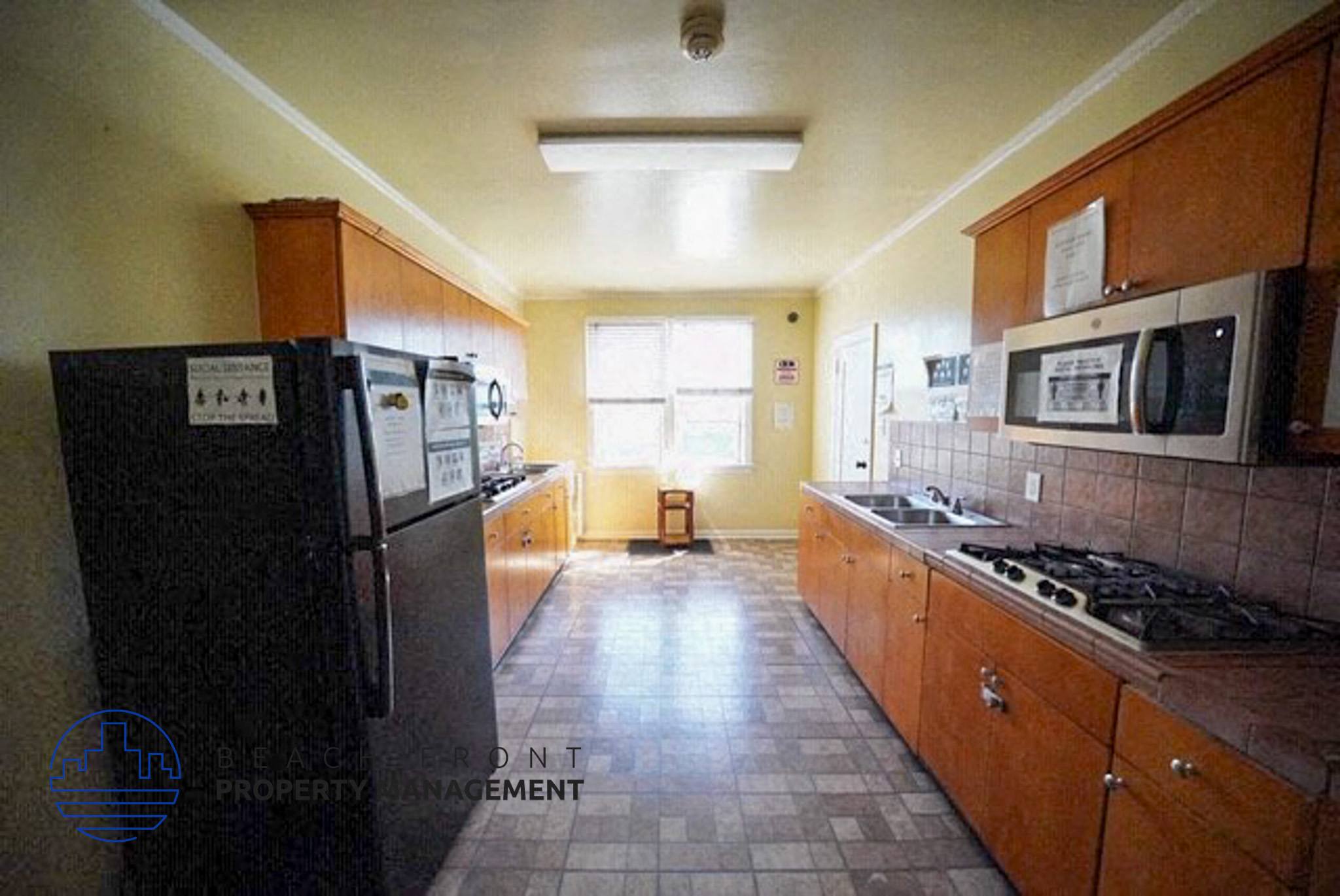 a kitchen with a refrigerator and a stove and a microwave