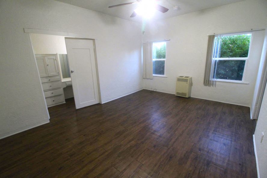 an empty living room with a hard wood floor