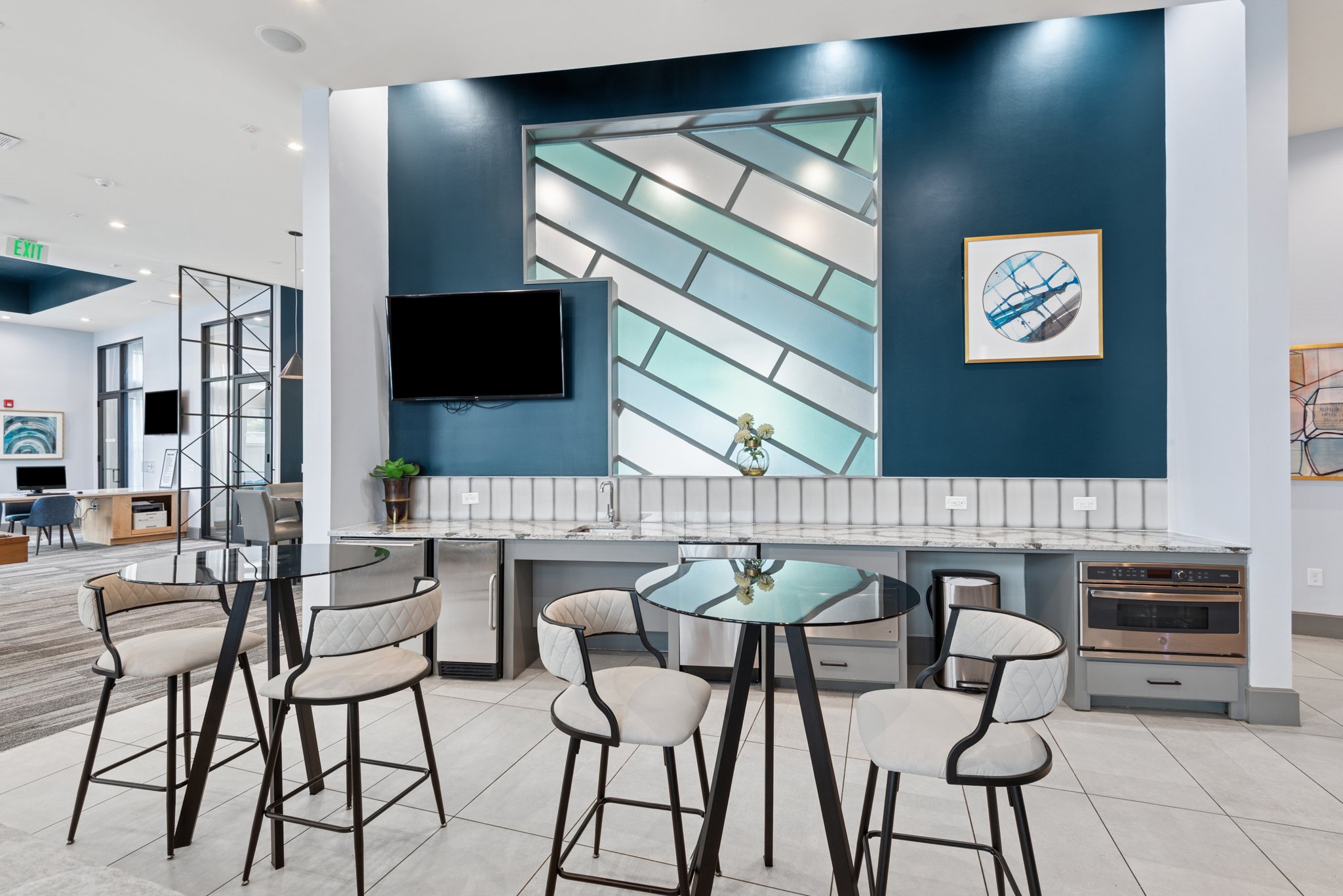 A modern dining area with a glass table and chairs.