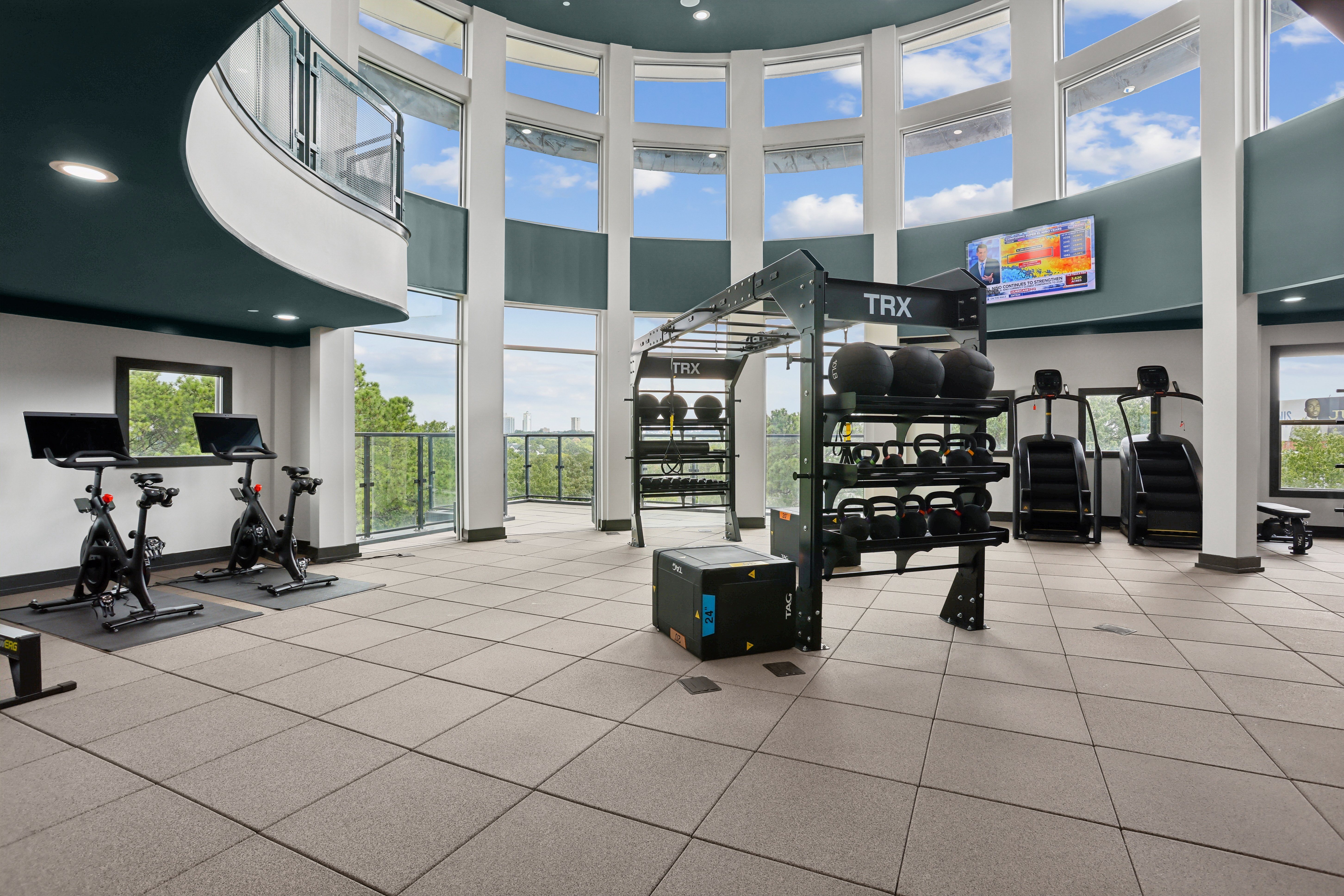 A gym with a TRX suspension trainer and stationary bikes.