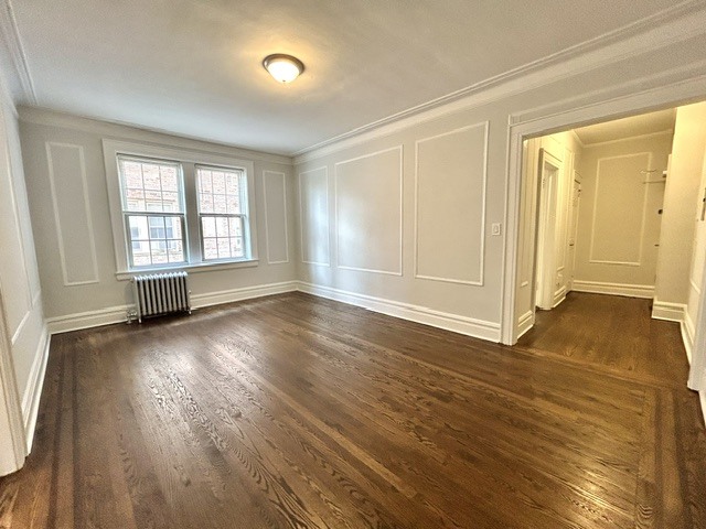 A room with wooden floors and white walls.