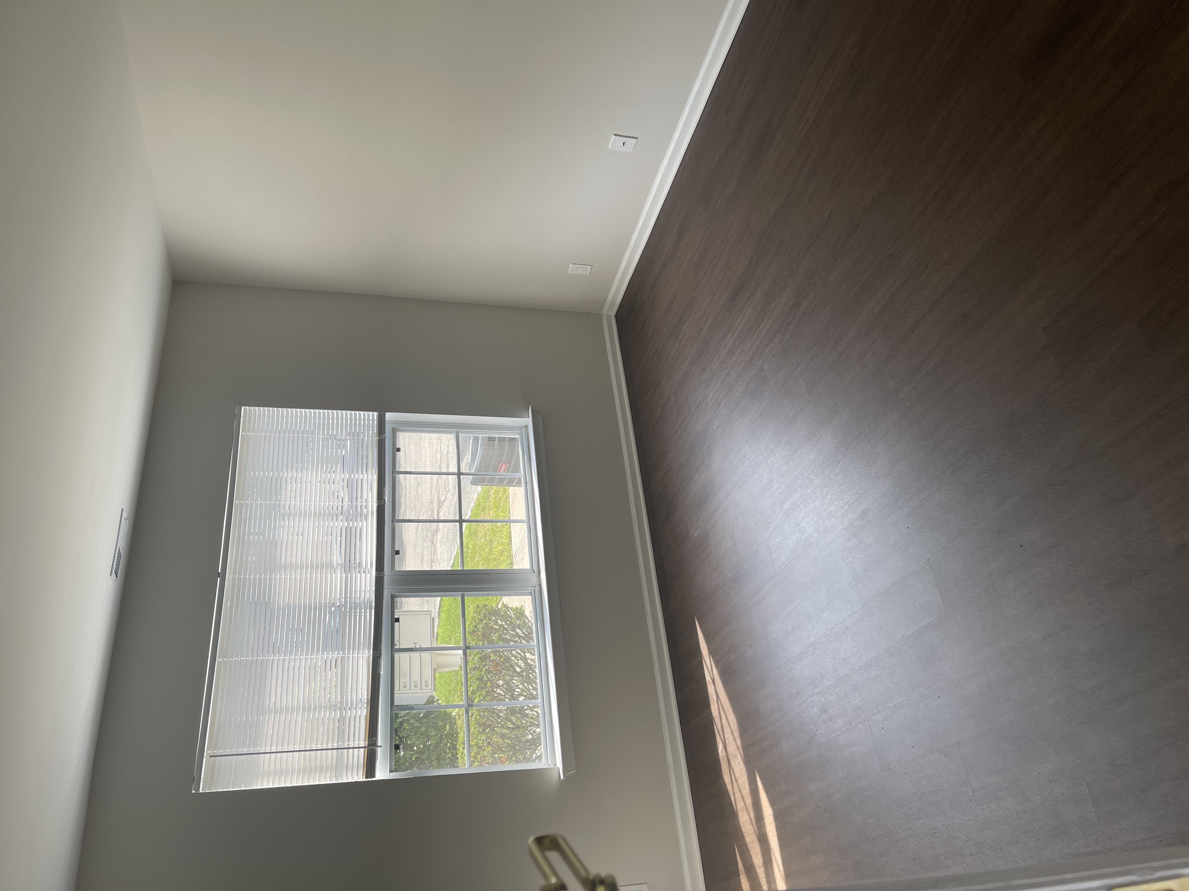 A window with blinds is open, letting in light.