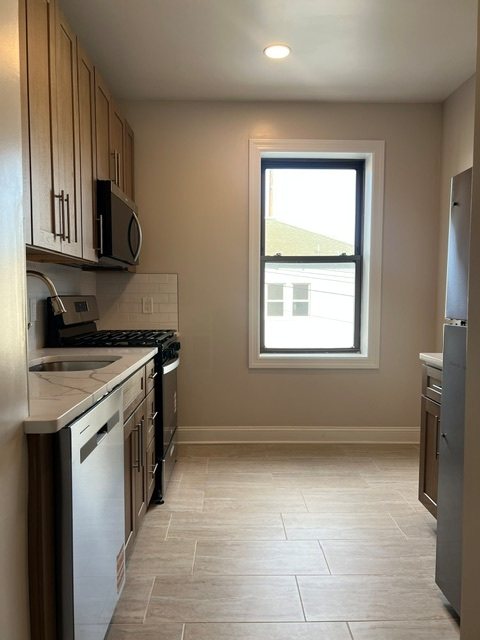 A kitchen with a window and a sink.