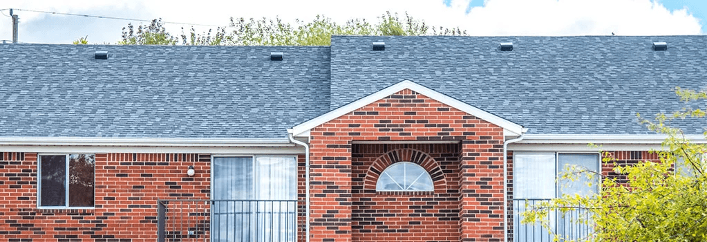 a brick house with a gray roof