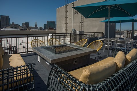 Apartments for Rent in Oakland - Rasa - Rooftop Lounge with Fire Pit, Umbrellas, Couches, and Tables