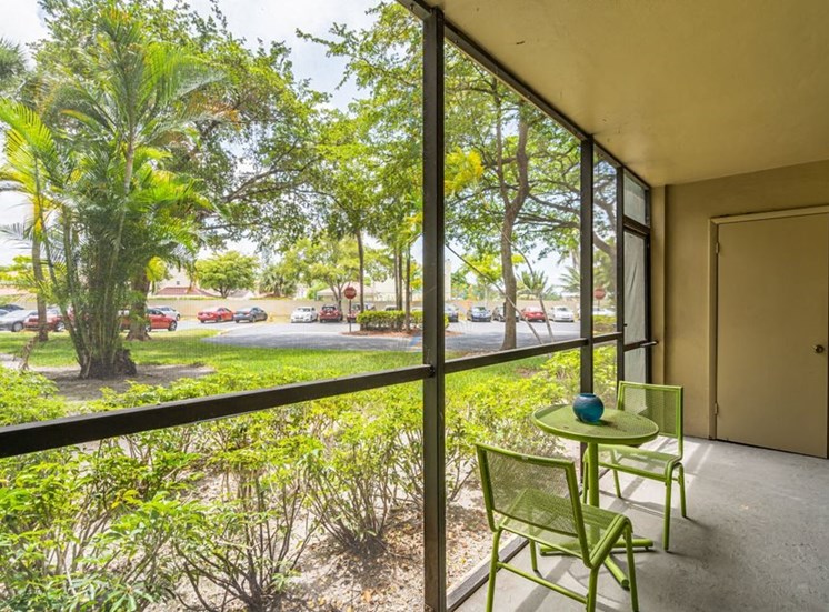 Apartments in North Miami - Spacious Screened Patio with Storage Room and View of Greenery