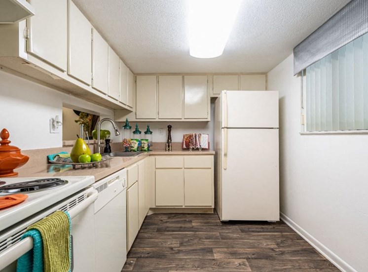Apartments in North Miami for Rent-Spacious Kitchen With Modern Flooring, Cream Cabinets and White Appliances.