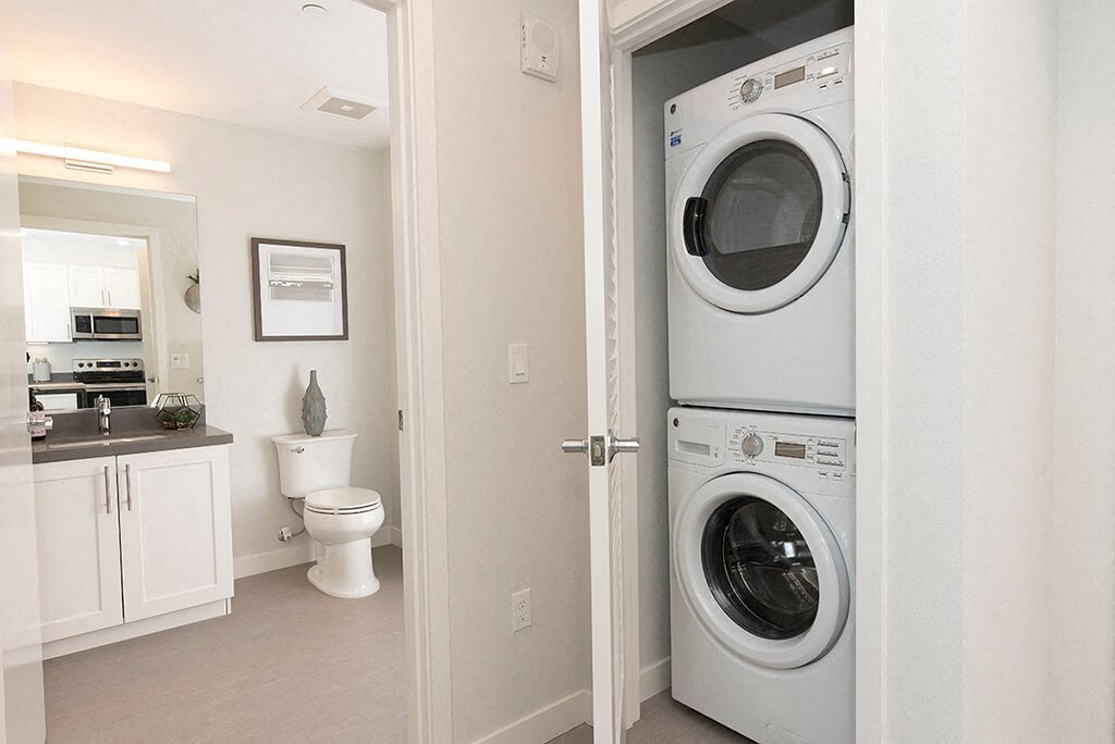 washer and dryer by bathroom l Orion Apartments in Oakland