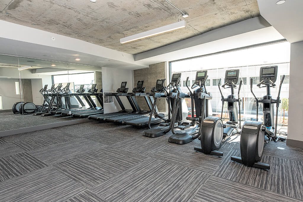 gym with cardio equipment   l Orion Apartments in Oakland