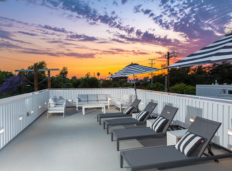 Rooftop with lounge chairs in the sunset