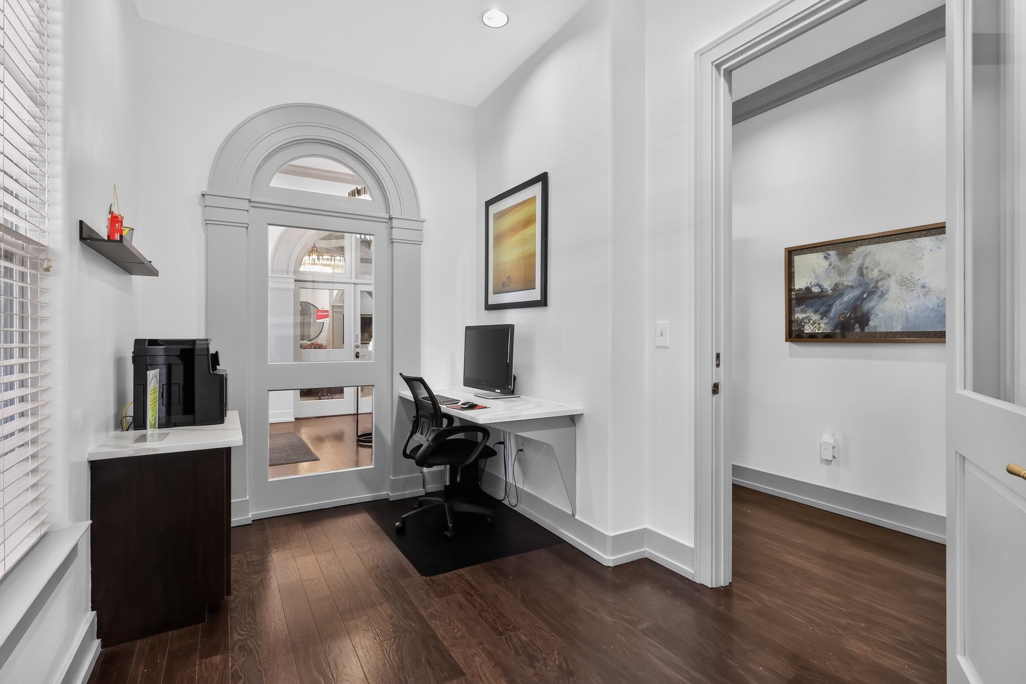 A room with a desk and a chair.