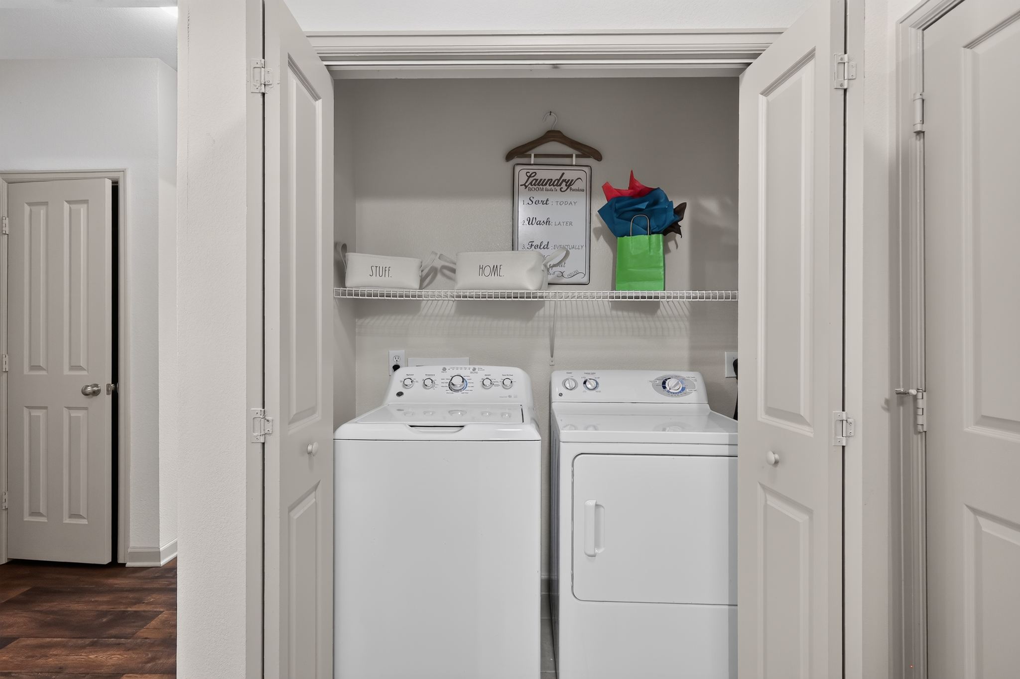 A small laundry room with a washer and dryer in it.
