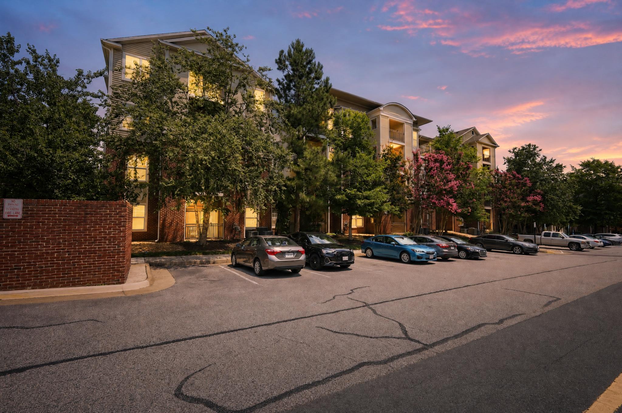 A building with a parking lot in front of it.