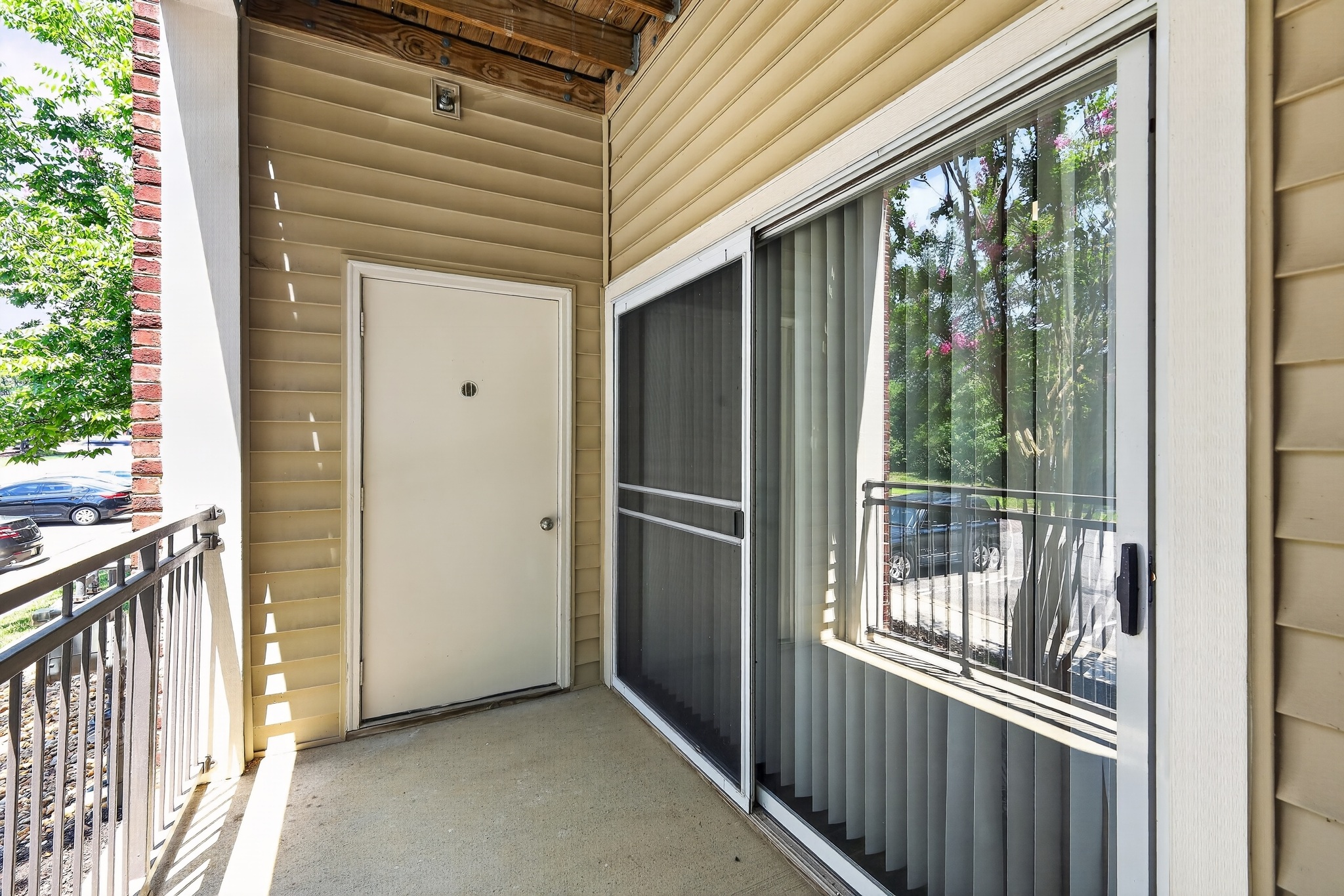 A white door is on the left and a sliding glass door is on the right.