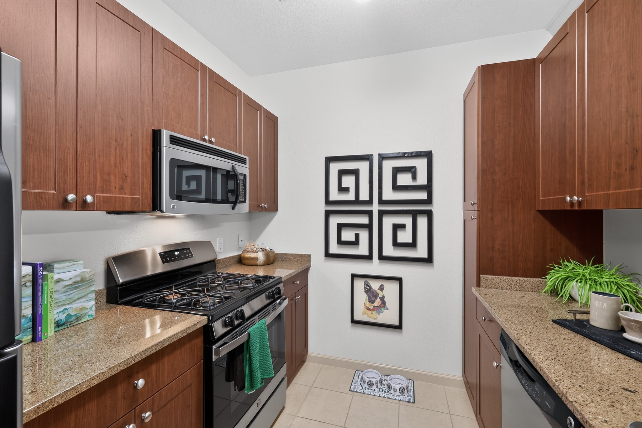 A kitchen with brown cabinets and a black stove top oven.