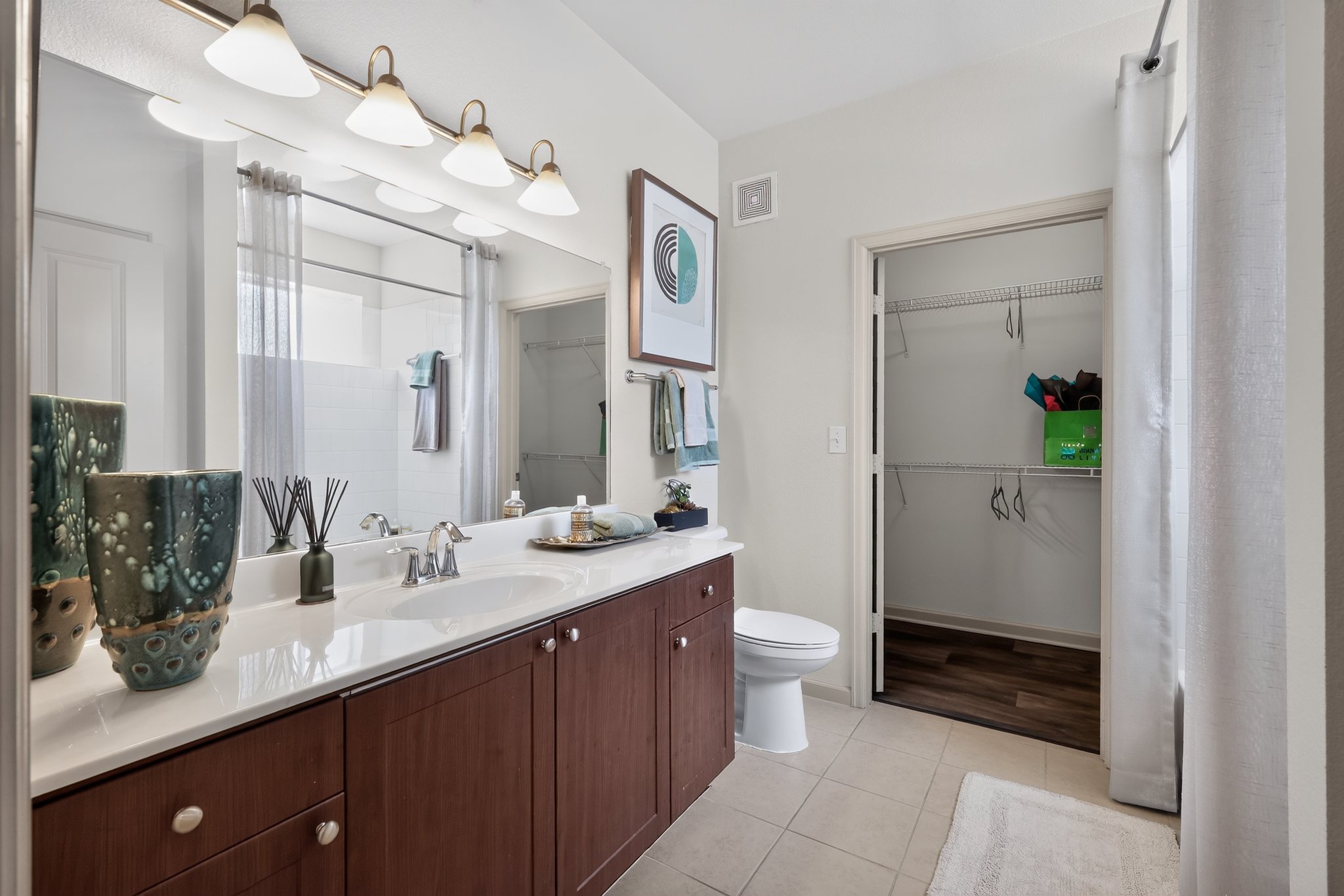 A bathroom with a white sink and a white toilet.
