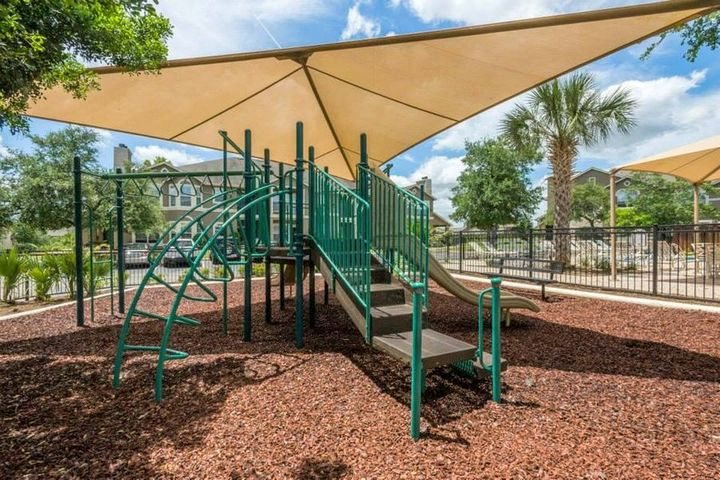 Pet-Friendly Apartments in San Antonio, TX - Covered Playground with Slide and Monkey Bars